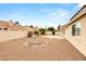 Expansive backyard showing the desert landscape, stucco wall, and ample space for outdoor enjoyment at 6209 Lenaking Ave, Las Vegas, NV 89122