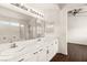 Dual sinks, vanity area, and large mirror in this bright bathroom at 6209 Lenaking Ave, Las Vegas, NV 89122