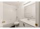 Clean bathroom features a shower over tub, a white vanity, and a mirror at 6209 Lenaking Ave, Las Vegas, NV 89122