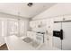 Bright kitchen displays white cabinets and appliances, a breakfast bar, and lots of natural light at 6209 Lenaking Ave, Las Vegas, NV 89122