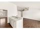 Kitchen with breakfast bar opens to a large empty room, providing ample space for entertaining or relaxation at 6209 Lenaking Ave, Las Vegas, NV 89122