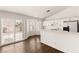 Bright kitchen features white cabinets, modern appliances, a breakfast bar, and sliding glass doors leading to the backyard at 6209 Lenaking Ave, Las Vegas, NV 89122
