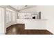 Bright kitchen with hardwood floors, modern white cabinetry, countertops, and stainless steel appliances at 6209 Lenaking Ave, Las Vegas, NV 89122