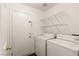 Functional laundry room with washer, dryer, and shelving at 6209 Lenaking Ave, Las Vegas, NV 89122