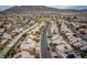 Aerial view of a suburban neighborhood with tile roofs, mountains in the background at 6276 Back Woods Rd, Las Vegas, NV 89142