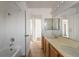 Spacious bathroom with double sinks, a large mirror, and a bathtub/shower combination at 6276 Back Woods Rd, Las Vegas, NV 89142