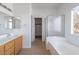 Bright bathroom features a double sink vanity and separate shower and bathtub at 6276 Back Woods Rd, Las Vegas, NV 89142