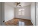 A bright bedroom with hardwood floors, a ceiling fan, and a view from the window at 6276 Back Woods Rd, Las Vegas, NV 89142