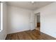 A well-lit bedroom with hardwood floors and an open doorway at 6276 Back Woods Rd, Las Vegas, NV 89142