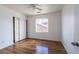 A bedroom with hardwood floors, a ceiling fan, and sliding door closets for storage at 6276 Back Woods Rd, Las Vegas, NV 89142