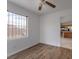 Cozy bedroom with hardwood floors and an open view to the kitchen at 6276 Back Woods Rd, Las Vegas, NV 89142