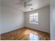 Bright bedroom features hardwood floors, a ceiling fan, and a view from the window at 6276 Back Woods Rd, Las Vegas, NV 89142