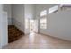Bright foyer with staircase and natural light streaming through the front door and windows at 6276 Back Woods Rd, Las Vegas, NV 89142