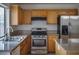 Kitchen featuring granite countertops, stainless steel appliances and wooden cabinets at 6276 Back Woods Rd, Las Vegas, NV 89142