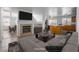 Bright living room featuring a fireplace, neutral decor, and open floor plan leading into the kitchen at 6276 Back Woods Rd, Las Vegas, NV 89142