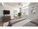 Bright bedroom with a large window, TV, and ensuite bathroom at 6276 Back Woods Rd, Las Vegas, NV 89142