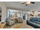 Inviting living room featuring hardwood floors, ceiling fan, and an open view into the dining room at 6470 Crest Estates St, Las Vegas, NV 89131