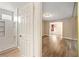 Bathroom with white shower and adjacent bedroom with hardwood floors and large closet at 6858 Groveview Ln, Las Vegas, NV 89103