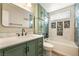 Bright bathroom features a sage vanity and tub with unique mosaic tile accents at 6858 Groveview Ln, Las Vegas, NV 89103