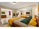 Staged bedroom with wood floors, mirrored closet, and comfortable furniture at 6858 Groveview Ln, Las Vegas, NV 89103