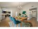 Dining room featuring a wood table, seating for six, and open access to the kitchen at 6858 Groveview Ln, Las Vegas, NV 89103