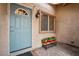 Home entrance with a decorative door, window, sconce, and potted plants enhancing curb appeal at 6858 Groveview Ln, Las Vegas, NV 89103
