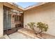 Close-up of a home entrance with a security gate and desert landscaping at 6858 Groveview Ln, Las Vegas, NV 89103