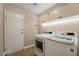 Functional laundry room with modern appliances and storage cabinets at 6858 Groveview Ln, Las Vegas, NV 89103