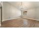 Well lit living room with light walls, wood floors, vaulted ceiling, and a chandelier at 6858 Groveview Ln, Las Vegas, NV 89103