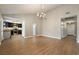 Spacious living room area with wood flooring, chandelier, and open access to the kitchen at 6858 Groveview Ln, Las Vegas, NV 89103