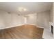 Bright living room with wood floors, neutral paint, and a decorative light fixture at 6858 Groveview Ln, Las Vegas, NV 89103