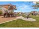 Community park featuring a playground, picnic table, grass, and desert landscaping at 6901 Whisper Canyon Pl, North Las Vegas, NV 89084