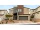 Contemporary two-story home with a two-car garage, desert landscaping and neutral colors at 6901 Whisper Canyon Pl, North Las Vegas, NV 89084