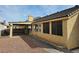 Exterior view of home with a covered patio and landscaped backyard at 6908 Fruit Flower Ave, Las Vegas, NV 89130