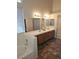 Bathroom featuring a soaking tub, dual sinks, and tiled floors providing a comfortable and functional space at 6908 Fruit Flower Ave, Las Vegas, NV 89130