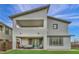 Spacious backyard with covered patio, artificial grass, and contemporary exterior design at 705 Carlon Hills Ave, Las Vegas, NV 89138