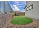 Private backyard featuring a putting green, rock landscaping, and a modern fence at 705 Carlon Hills Ave, Las Vegas, NV 89138
