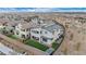 Aerial view of a modern home with a backyard featuring artificial turf and patio seating at 705 Carlon Hills Ave, Las Vegas, NV 89138