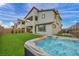 Spacious backyard featuring a well-maintained lawn, a modern hot tub, and a multi-story home at 705 Carlon Hills Ave, Las Vegas, NV 89138