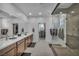 Spa-like bathroom featuring double sinks, sleek countertops, and a luxurious glass-enclosed shower with stone accents at 705 Carlon Hills Ave, Las Vegas, NV 89138