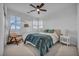 Inviting bedroom with a ceiling fan, neutral decor, and large windows that let in natural light at 705 Carlon Hills Ave, Las Vegas, NV 89138