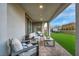 Inviting covered patio with comfortable seating, brick pavers, and a view of the manicured backyard at 705 Carlon Hills Ave, Las Vegas, NV 89138