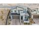 Modern two-story home featuring a paved driveway, front patio, and desert landscaping at 705 Carlon Hills Ave, Las Vegas, NV 89138