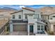 Contemporary two-story home boasts a modern design, mountain views, and a teal-colored front door at 705 Carlon Hills Ave, Las Vegas, NV 89138