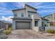 Contemporary two-story home with desert landscaping, brick driveway, and mountain views at 705 Carlon Hills Ave, Las Vegas, NV 89138