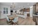 Open-concept kitchen and dining area featuring a large island, modern lighting, and wood-style flooring at 705 Carlon Hills Ave, Las Vegas, NV 89138