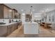 Modern kitchen with a large island, stainless steel appliances, and an open layout connecting to the dining area at 705 Carlon Hills Ave, Las Vegas, NV 89138