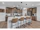 Well-lit kitchen features a large island with bar seating, stainless steel appliances, and stylish pendant lighting at 705 Carlon Hills Ave, Las Vegas, NV 89138
