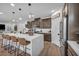 Stylish kitchen with bar seating, stainless steel appliances, and an open view to the living area at 705 Carlon Hills Ave, Las Vegas, NV 89138