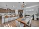 Bright kitchen with stainless appliances, quartz counters, a large island, and dining table at 705 Carlon Hills Ave, Las Vegas, NV 89138